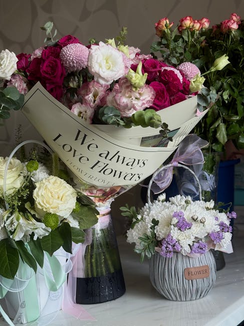 A street scene featuring a flower vendor pushing a bicycle loaded with a large, colorful floral arrangement. The bouquet includes pink roses, white hydrangeas, yellow lilies, and greenery, wrapped in 